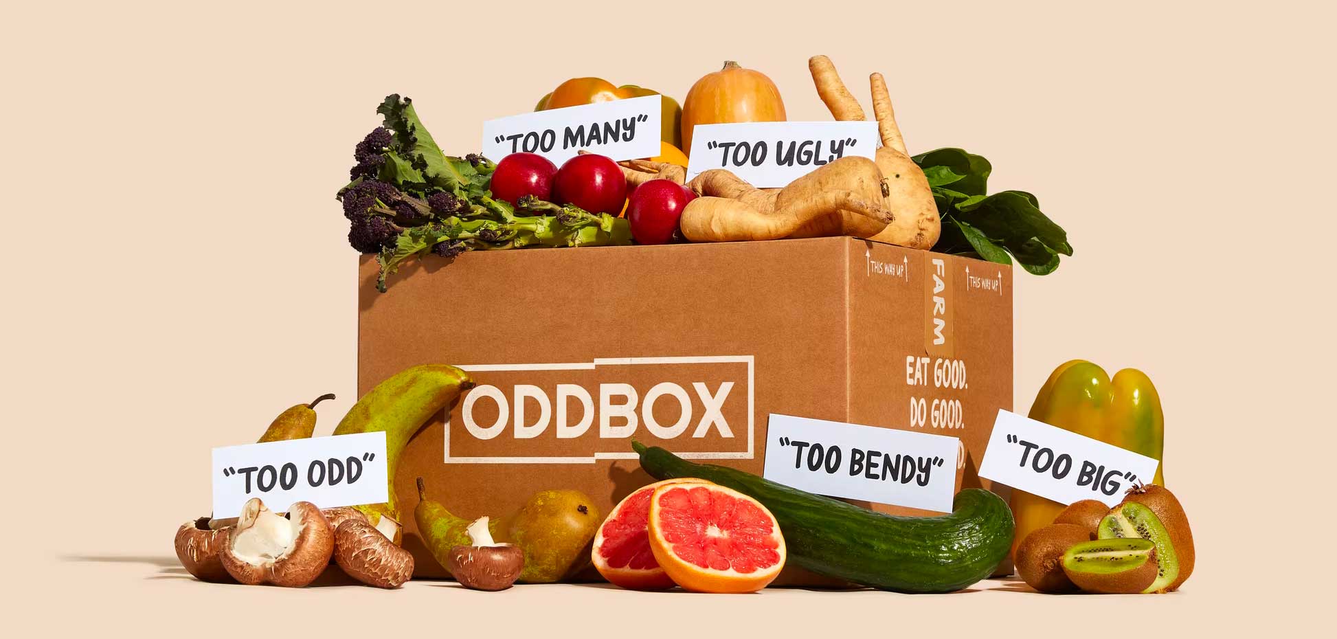 Oddbox box piled with fruit and vegetables labelled "too many", "too odd", etc.
